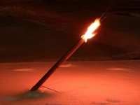 road fusee flare with stand burning on road at night time.