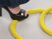 Yellow Non-skid braided sleeving covering wires on floor