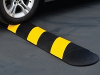 Rubber speed bump, yellow/black in use