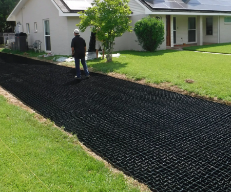 Geogrid permeable paving tile in use with gravel and soil for home driveway Geogrid permeable paving tile in use with gravel and soil for home driveway