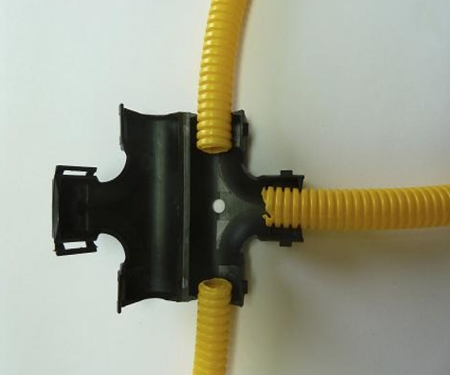Black wire loom tee connector in use