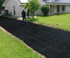 Geogrid permeable paving tile in use with gravel and soil for home driveway